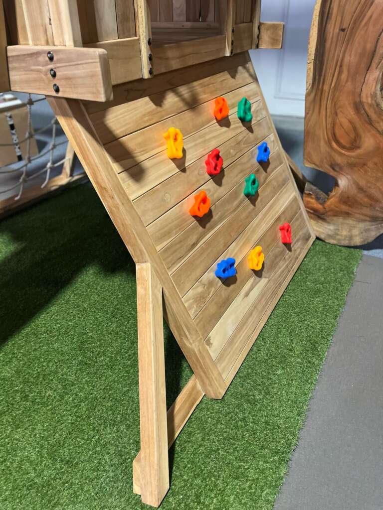 Vue latérale d’une aire de jeux en teck avec accès par cordage